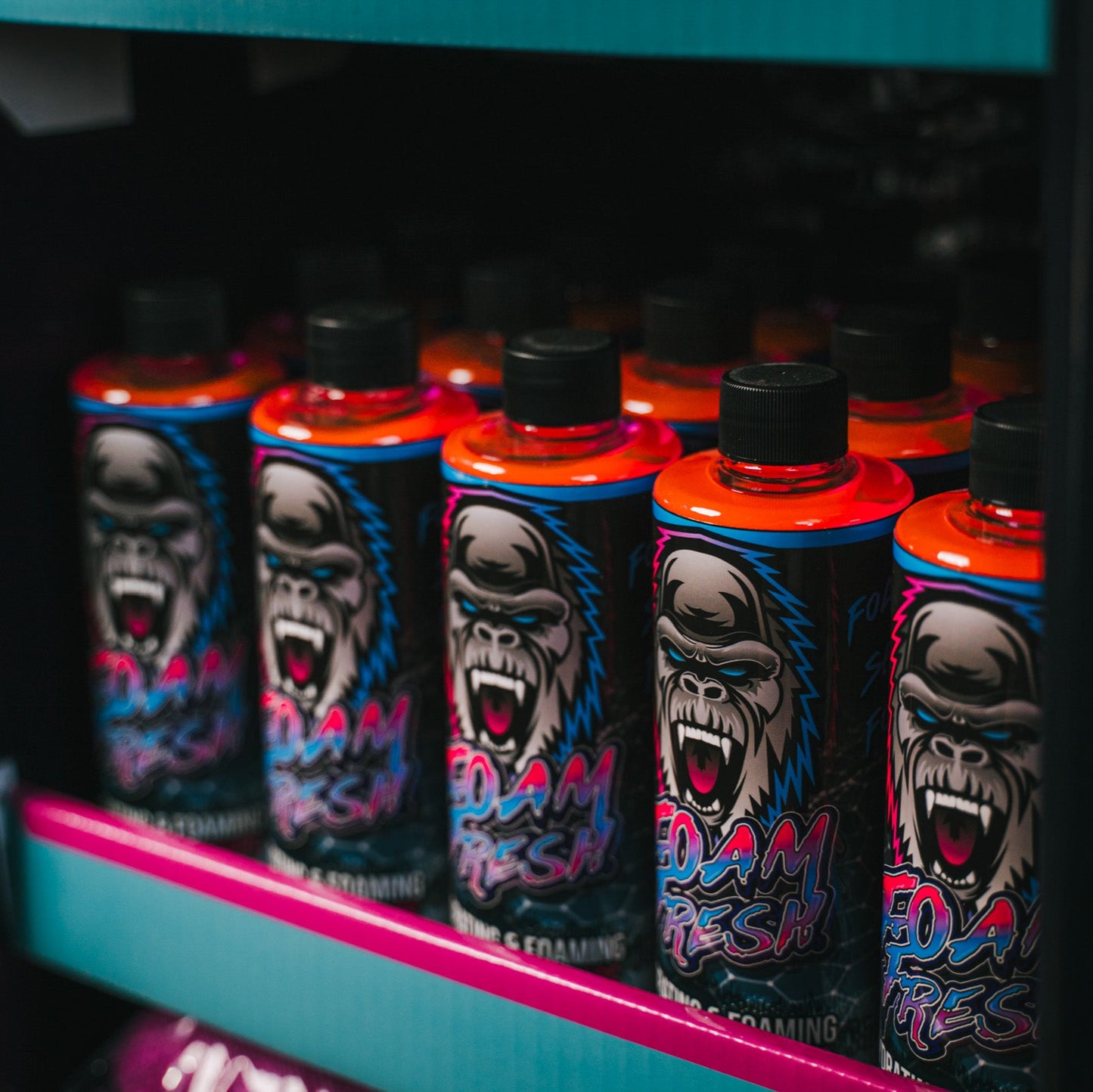row of car wash shampoo bottles on a shelf