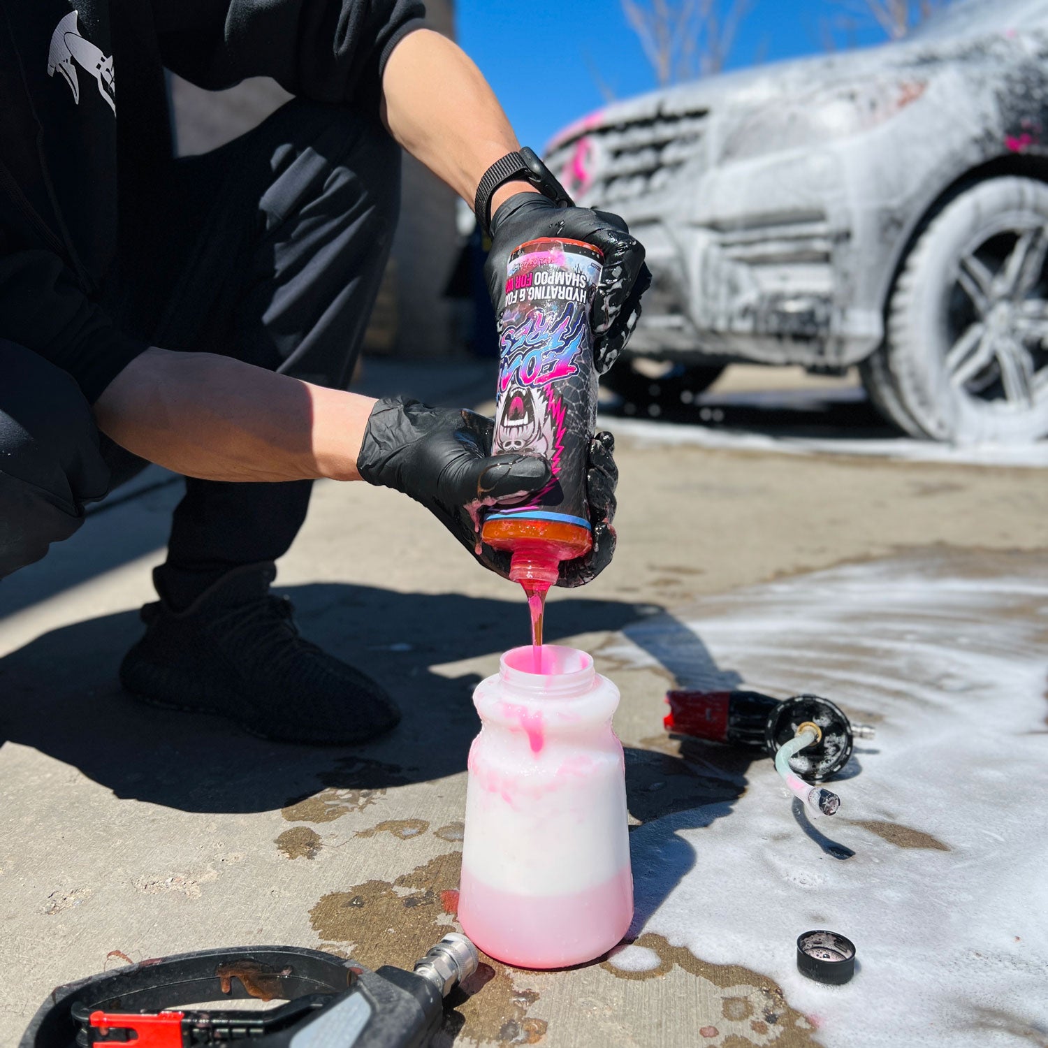 Squeezing a Foam Fresh bottle into a foam cannon